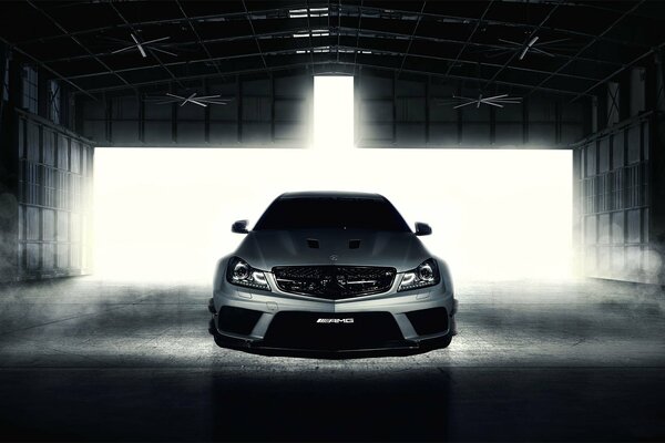 Full-face black and white photo of a car in the garage