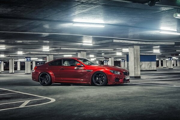 Red bmw in an underground parking lot