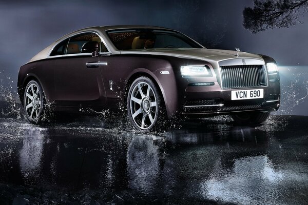 Rolls Royce car through puddles on the night road