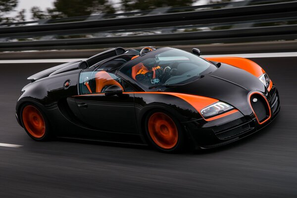 Black bugatti veyron grand sport roadster on the track