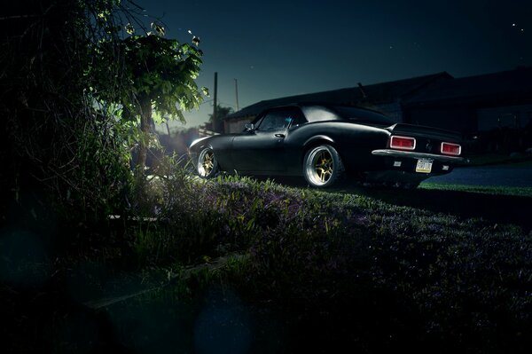 Black Chevrolet Camaro. Camaro rear at night