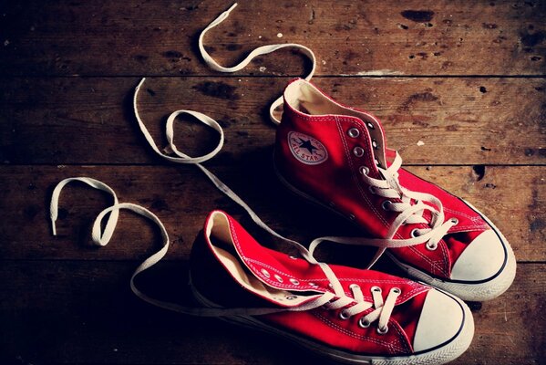 Red sneakers on the wooden floor