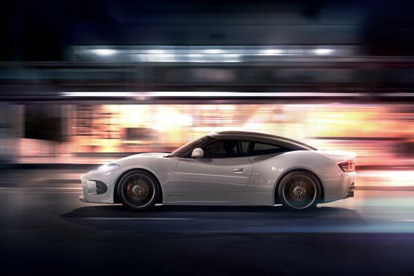 The car is at speed. White car. Beautiful photo of a car. Auto at night