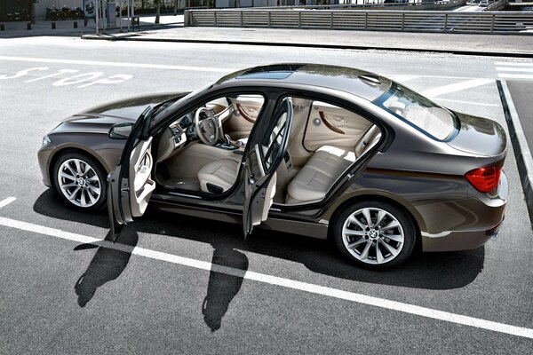 A silver bmw is parked in the parking lot