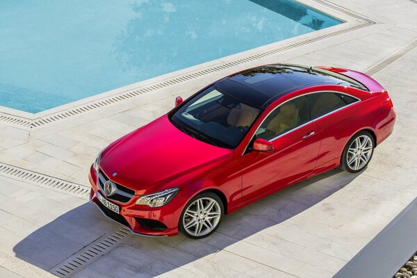 Beautiful photo of a car. Car photo from above. Mercedes. The car is near the pool. Expensive car . The red car. A car for a girl