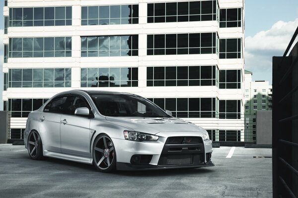 Mitsubishi evolution x silver at the white building