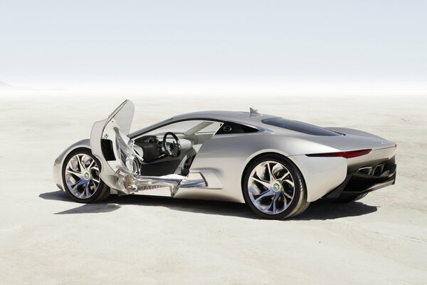 Jaguar c-x75 car stands on the sand