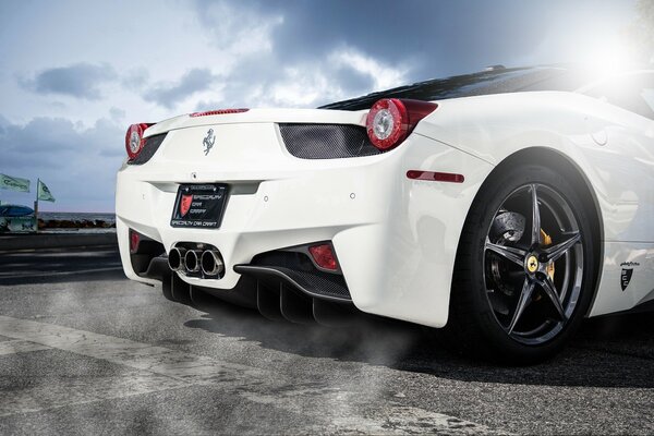 White Ferrari against a cloudy sky