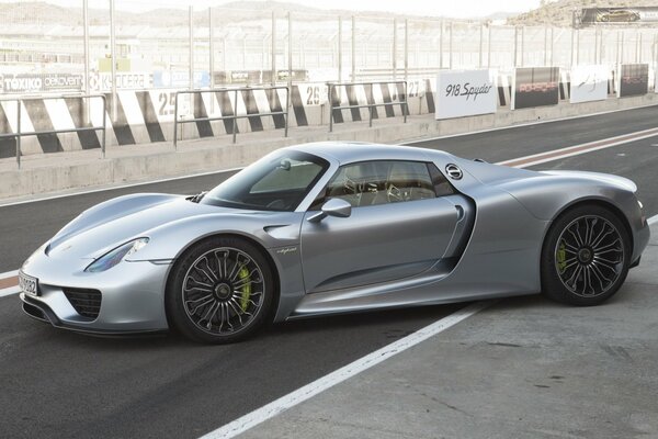 Silver Porsche Spider supercar on the track