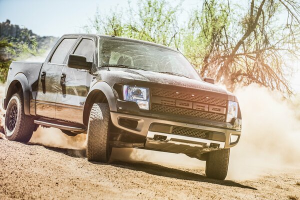 Ford Charles pickup truck in a skid in the desert