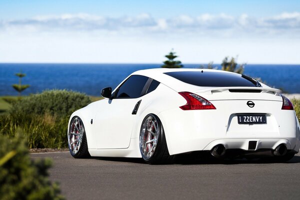 On the wings of happiness in a Nissan 370z white car