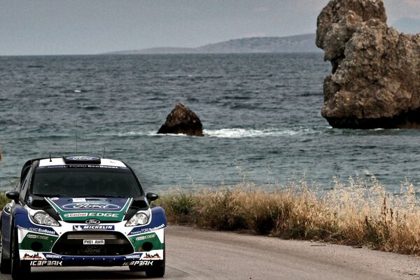 Coche de carreras en la pista junto al mar