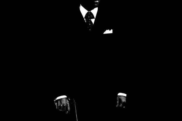 Black and white photo of a man in a tuxedo