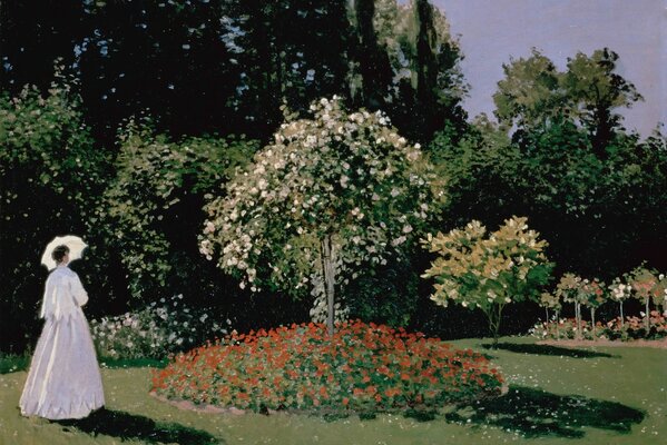 An exquisite girl in a white dress with a white umbrella admiring a flowering tree in the garden