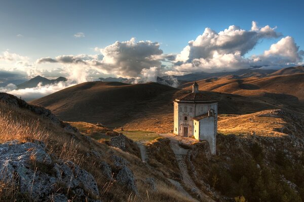 Church sky and mountains with stones