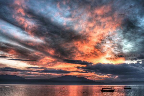 Boats on the sea surface under the sunset sky