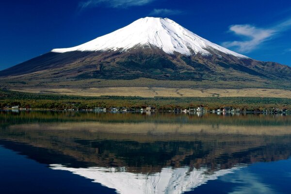 A mountain with a snow top near the river bank