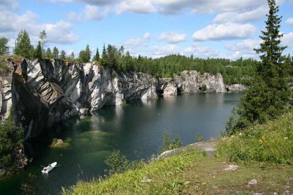 Boat on the river with high rocks