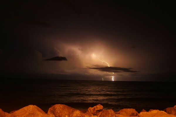 Lightning in the sky at night at sea