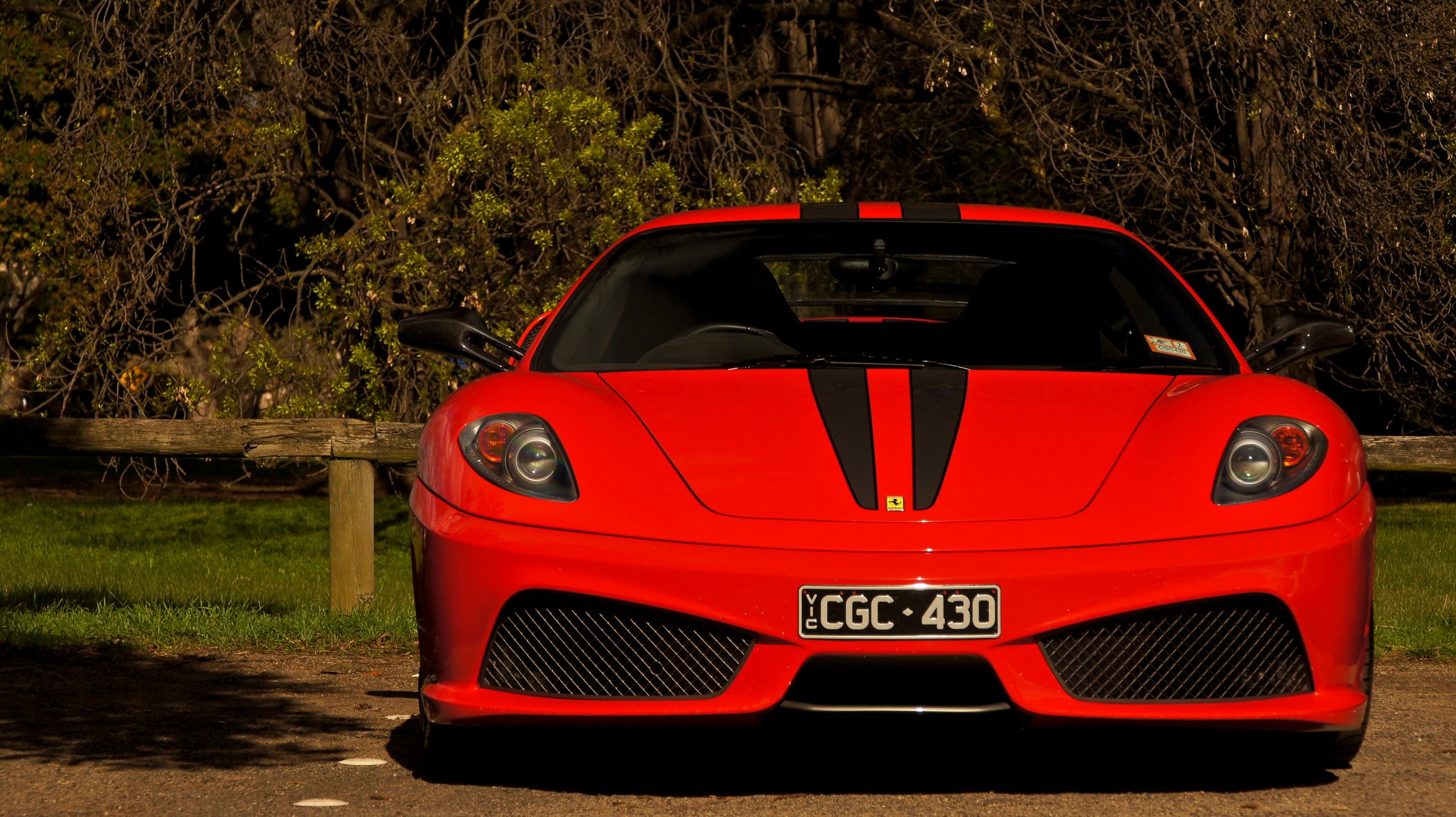 ferrari f430 scuderia rot supersportwagen vorne zaun bäume