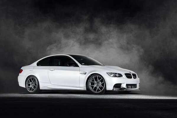 BMW m3 white on the side on a gray background in smoke