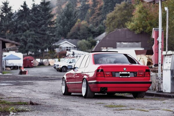 A red tuned car on a village street