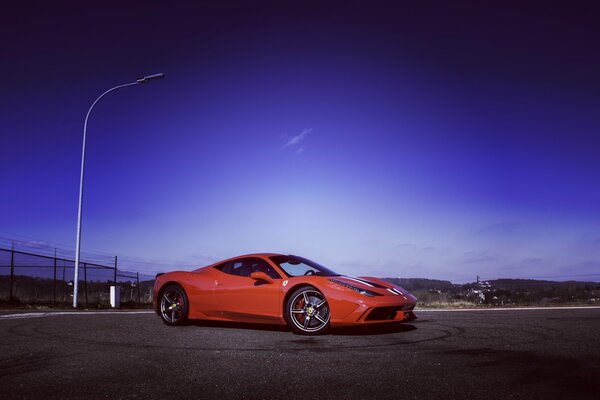 Red Ferrari at the training ground in the evening