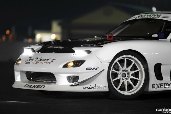 White mazda with tuning in the night
