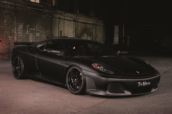 Matte Ferrari f430 on the background of a brick fence