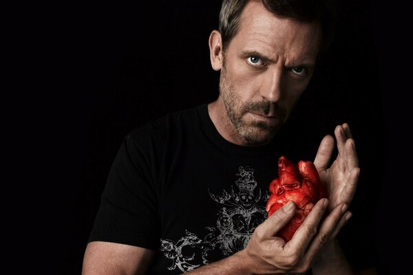 Red heart in the hands of an actor