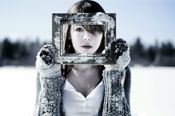 Frozen model in the snow with a photo frame