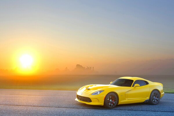 Yellow car foreign car on the background of the sun