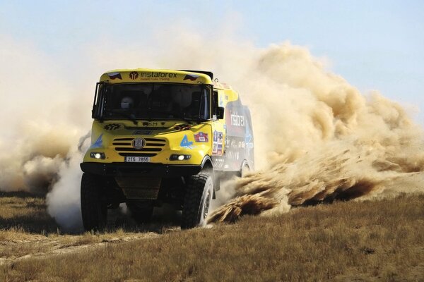 Sand is scattered from the wheels of the truck