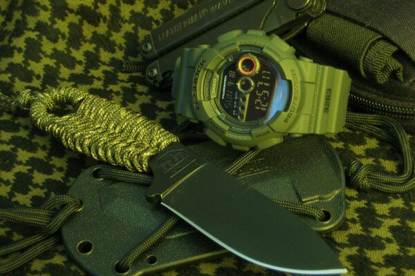 A set for a real man:a multitool knife with a braid on the handle and a watch