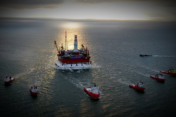 Oil well in the sea with ships