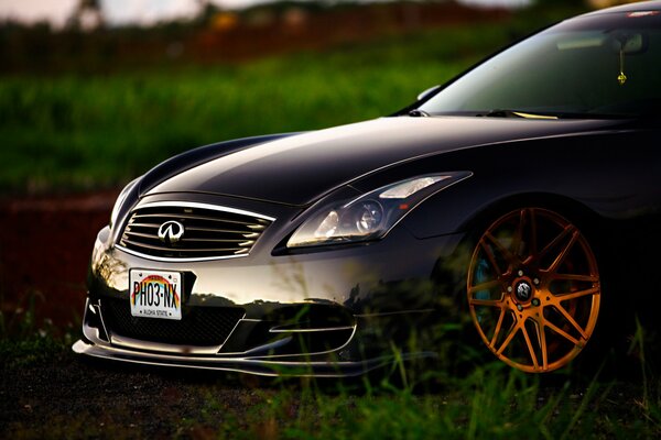 Tuned Infiniti car with copper-colored discs