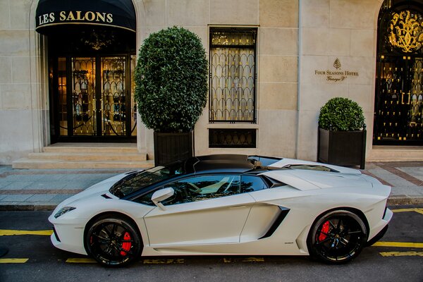 Weißer Lamborghini Aventador auf dem Hintergrund des Gebäudes