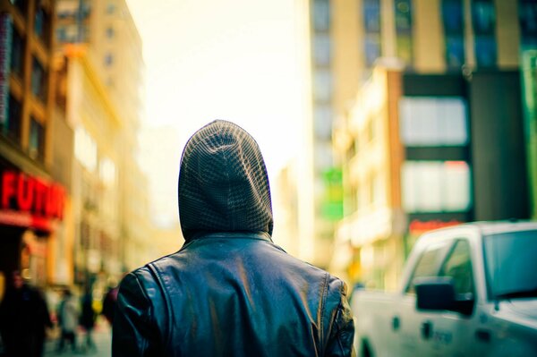 A passerby in a hood in a big city