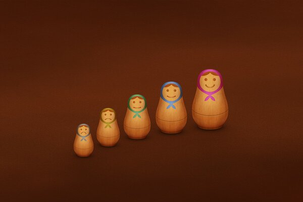 Five nesting dolls on a brown background