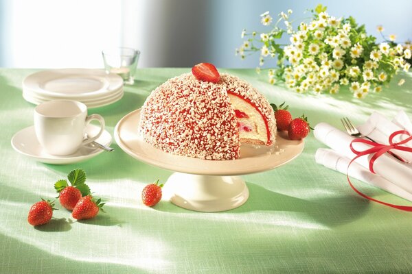 Strawberry cake, flowers and dishes