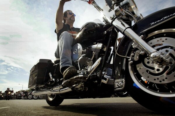 A man with a motorcycle at a biker gathering