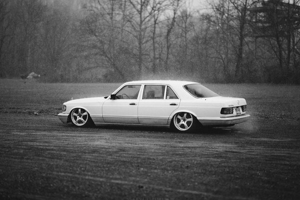 White Mercedes on the road in rainy weather