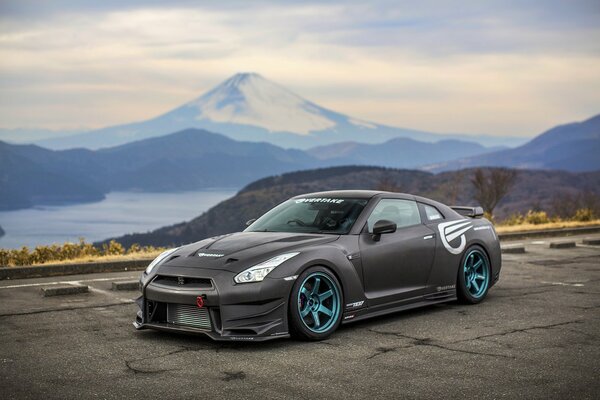 Tuning Nissan on the background of mountains