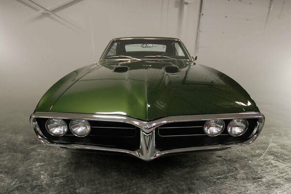 A green Pontiac in a gray fog