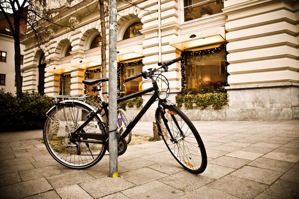 Bicycle on the street against the background of the wind