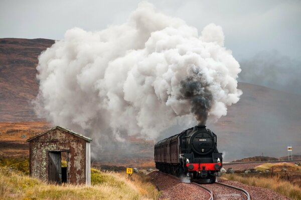 A railway locomotive and an abandoned house