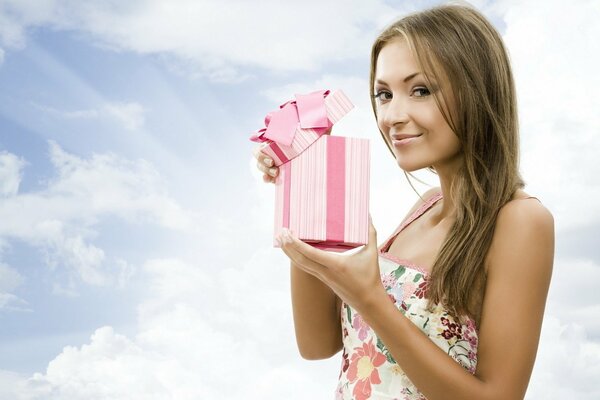 A girl opening an attractive pink gift