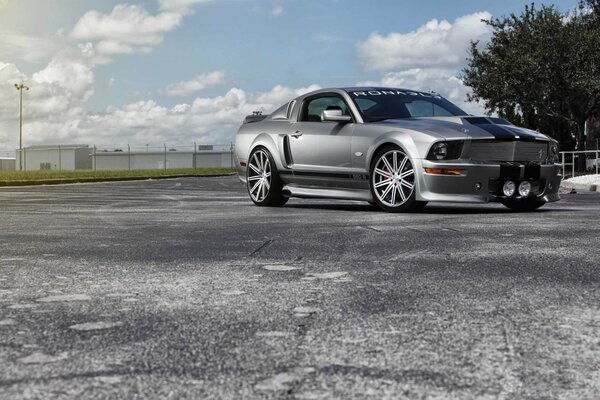 Silberner Ford Mustang unter den Wolken