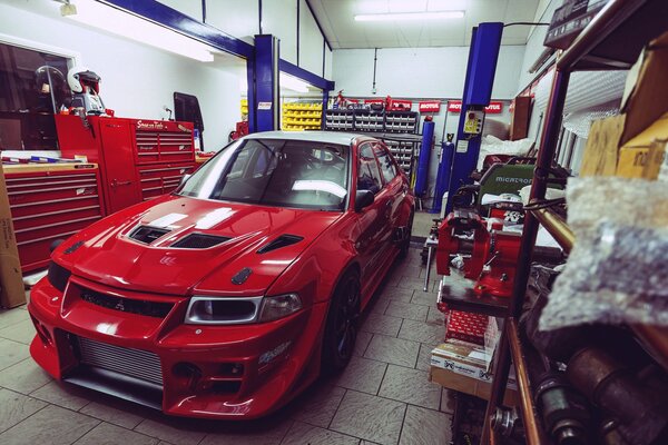 Red Mitsubishi Lancer Evolution in the garage