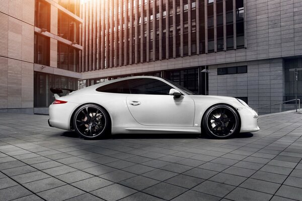 White Porsche 911 on the background of the building